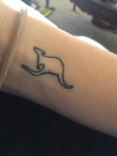 a person with a tattoo on their arm that has a kangaroo in the middle of it