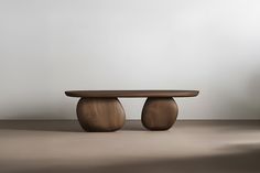 a wooden table sitting on top of a floor next to a white wall and chair