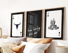 three framed pictures hang on the wall above a bed