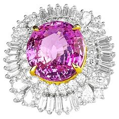 This exquisite "Queen Pink" ring is a true masterpiece of the jewelry world. This stunning piece boasts a remarkable 10-carat natural untreated pink sapphire, one of the world's most precious and rare gems. As the value and desirability of pink sapphire gems have skyrocketed in recent years, the "Queen Pink" ring has become an even more remarkable and coveted treasure. The main feature of the "Queen Pink" gem is a 10.11-carat pink sapphire of exceptional quality, with a vivid pink color and rema Gia Certified Pink Sapphire Rings For Formal Occasions, Gia Certified Fine Jewelry Pink Sapphire Diamond Ring, Fine Jewelry Gia Certified Pink Sapphire Diamond Ring, Gia Certified Pink Sapphire Diamond Ring, Gia Certified Pink Sapphire Diamond Ring In Fine Jewelry, Formal Pink Cluster Ring With Brilliant Cut, Luxury Gia Certified Pink Sapphire Diamond Ring, Gia Certified Pink Sapphire In White Gold Ring, Gia Certified White Gold Ring With Pink Sapphire