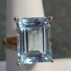 R167 $269 Aquamarine Cocktail Ring Size 7 14.50ct Aquamarine Emerald Cut Diamond Cocktail Or Engagement Ring 14k Yellow Gold Over 925 Sterling Silver Beautiful Bold Aquamarine Ring. All Weights And Measurements Are Approximate. Elegant Emerald Cut Blue Gemstones, Elegant Blue Emerald Cut Gemstones, Blue Solitaire Emerald Ring In Classic Style, Blue Solitaire Emerald Ring Classic Style, Classic Blue Emerald Ring With Accent Stones, Classic Solitaire Gemstones For Formal Occasions, Classic Aquamarine Rings For Formal Occasions, Classic Emerald Cut Blue Topaz Jewelry, Formal Octagon Solitaire Sapphire Ring