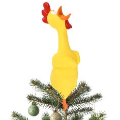 a yellow chicken sitting on top of a christmas tree