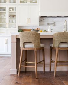 two chairs are sitting at the kitchen island