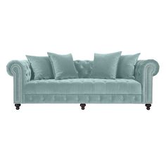 a light blue couch with pillows on it