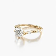 a yellow gold engagement ring with an oval cut diamond