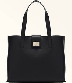 From Furla&#x2C; the 1927 Large 36 Soft Tote Bag features:Grained leatherCentral partition with zip closureTwist closure with the Furla logo engraved on the front Spacious and versatileMetal feet Approx.: 14.17" L x 11.22" H x 5.70" WImported. Classic Bags With Double Handle And Logo Hardware, Classic Bags With Logo Hardware And Double Handle, Classic Rectangular Shoulder Bag With Logo Hardware, Everyday Shoulder Bag With Logo Hardware, Classic Everyday Shoulder Bag With Logo Hardware, Classic Travel Bags With Logo Hardware, Leather Business Bags With Logo Hardware, Classic Satchel Bags With Logo Hardware, Modern Bags With Logo Hardware For Daily Use