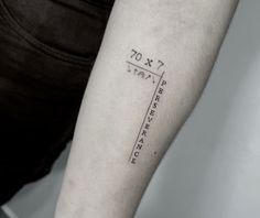 a person with a tattoo on their arm has a height chart tattooed on his arm