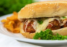 a meatball sandwich on a plate with chips