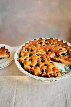 a blueberry pie on a table with two plates