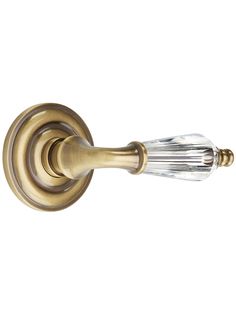 an antique brass door handle with crystal glass knobs