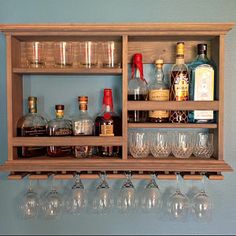 a shelf filled with lots of bottles and glasses