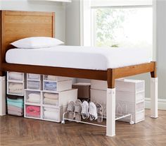 a bed that has some drawers underneath it