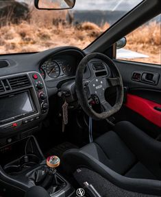 the interior of a car with steering wheel and dashboard