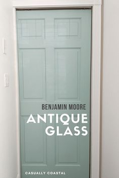 an antique glass door with the words benjamin moore on it in front of a white wall