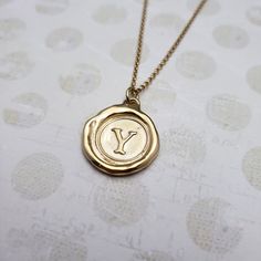 "Monogram Initial letter \"Y\" Materials: Silver, Gold, Gold vermeil Gold vermeil is a thick 24k layer of gold over a solid sterling silver base. Size: Approx 3/4\" {21mm} The antique wax seals used to make my initials are mostly around 170 yrs but can be as young as 70 yrs, and as old as 750+ yrs old (My letter i). As each wax seal was individually collected, I am unable to change the font or size. They are only available as shown. PLEASE NOTE: Before you order please check sizing information - it can be hard to gauge jewelry sizes from pictures alone. On some of the seal pieces the text is so small as to be read only with a magnifying glass making the meaning a secret between you and those you choose to tell. Availability and shipping Your purchase will ship in 3-5 business days. Once sh Classic Gold Stamped Necklace, Gold Stamped Initial Pendant Necklace, Gold Stamped Pendant Charm Necklace, Gold Stamped Initial Pendant Charm Necklace, Gold Medallion Necklace With Stamped Detail, Monogram Wax Seal, Wax Seal Pendant, Seal Jewelry, Jewelry Letter