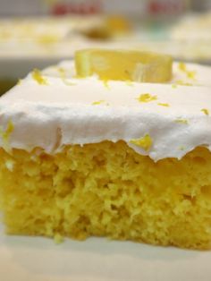 a piece of cake with white frosting sitting on a plate