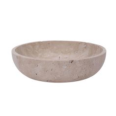 a large stone bowl sitting on top of a white surface with no one around it