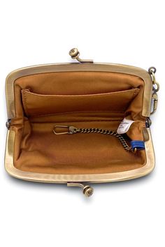 Add a touch of personality to any bag or keychain by layering on our Cheer bag charm, perfect for holding your AirPods and small essentials. Cheer has a vintage-inspired frame design with enough room to hold small essentials. FEATURES Sandlewood Lining Interior Features: Key clip Brushed Antique Brass Hardware Frame Clasp Closure MEASUREMENTS 5.5" W X 3.5" H X 1" D Vintage Rectangular Coin Purse For Everyday, Travel Coin Purse With Key Clip, Gold Pouch Satchel With Gold-tone Hardware, Coated Canvas Pouch Shoulder Bag With Gold-tone Hardware, Gold Coin Purse With Interior Key Chain Holder, Blue Vintage Wallets For Everyday Use, Vintage Blue Wallets For Everyday Use, Compact Coin Purse With Interior Key Chain Holder, Gold-tone Hardware Pouch Bag