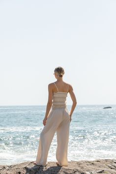 FINAL SALE. Elevate your warm weather wardrobe with the Vero Woven Smocked Tank Pants Set. This matching set features smocked detailing with contrasting stitching, adding a touch of effortless to your look. Stretch Smocked Top With Elastic Waistband For Beach, Beige Smocked Top For Summer Day Out, Spring Vacation Bottoms With Smocked Back, Chic Sleeveless Smocked Top With Elastic Waistband, Chic Smocked Sleeveless Top With Elastic Waistband, Sleeveless Smocked Top With Elastic Waistband For The Beach, Summer Smocked Top With Stretch And Elastic Waistband, Stretch Smocked Top With Elastic Waistband For Summer, Casual Smocked Top For Beach