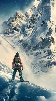 a man standing on top of a snow covered slope next to a tall snowy mountain