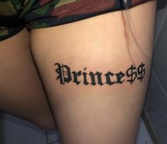 a woman's thigh with the word princess tattooed on her lower leg, in black ink