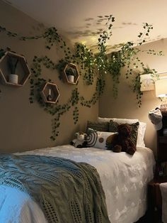 there is a bed with plants growing on the wall above it and two teddy bears