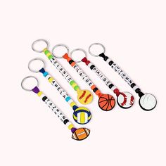 six key chains with different designs and colors on them, each featuring a basketball ball