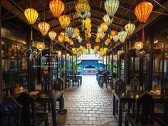 a restaurant with lanterns hanging from the ceiling