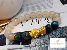 Gift yourself or your love once this 24 Karat Gold Lucky  Pi Xiu Bracelet.  *Materials: 24 Karat Gold , Agate, and Tiger's Eye Stone. *Karat: 24k Au999 *Gold Color: Yellow *Weight: Approx. 30g *Length: 6 Inches to 8 Inches *Gold Mass: Approximately 1.12g-1.30g *Stone Size: Approx.  10.3mm *Pixiu Length: Approx .93 Inches Real 24K Gold. NOT gold filled. Not gold Plated. Hallmarked 🧧The meteological creature Pixiu, Bixie or Tianlu is believed to guard and accumulate wealth.  If your having bad luck financially or you want to guard your wealth, then Pixiu is the perfect choice for you. 💥PLS FOLLOW US AND CHECK OUR OTHER LISTINGS. WE HAVE NEW STOCKS LISTED DAILY/WEEKLY.  📬S H I P P I N G WE SHIP WITHIN 24 HOURS. Free shipping in the US and International orders. Gold Spiritual Crystal Bracelet For Gift, Spiritual Gold Bracelet With Round Beads As Gift, Gold Beaded Good Luck Bracelets, Gold Crystal Bracelet With 8mm Beads As A Gift, Gold Bracelets With Round Beads For Good Luck, Gold Spiritual Bracelet For Good Luck, Traditional Gold Bracelets As Gifts, Gold Spiritual Bracelets As Gifts, Traditional Gold Bracelet