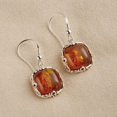 The Fossilized Baltic Amber Earrings - Hammacher Schlemmer Silver And Amber Earrings, Brown Baltic Amber Round Jewelry, Brown Baltic Amber Jewelry, Round Baltic Amber Jewelry In Amber Color, Amber Dangle Earrings With Ear Wire, Round Brown Baltic Amber Jewelry, Round Baltic Amber Jewelry, Elegant Brown Jewelry With Polished Finish, Elegant Brown Polished Jewelry