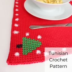 a red placemat with a green christmas tree on it next to a bowl of oatmeal