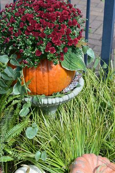 a planter filled with lots of flowers and plants