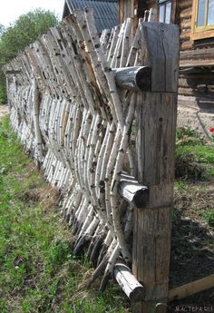 a wooden fence made out of sticks and logs