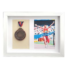 an olympic medal is displayed in a white frame