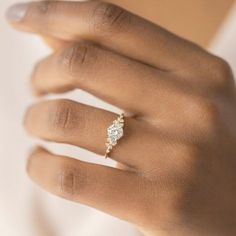 a woman's hand with a diamond ring on it