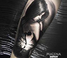 a woman's arm with a black and white tattoo design on the left forearm