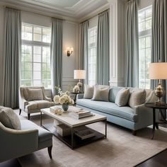 a living room with couches, chairs and tables in front of two large windows