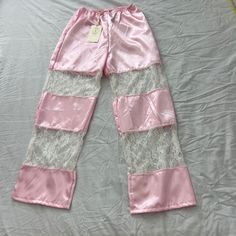 Urban Outfitters Lace Insert Silky Pull-On Pant Size S/M Condition: Nwt Color: Pink / White Details : - Silky Pants From Urban Renewal With Lace Paneling And An Elastic Waistband Approx. Measurements: - Length: 39 Inches - Rise: 12 Inches - Inseam: 30 Inches - Waist: 28 Inches - Leg Opening: 9 Inches Extra: - I Ship Between 1-2 Days Fitted Lace Trim Pants For Loungewear, Fitted Lounge Pants With Lace Trim, Chic Pink Bottoms For Pajama Party, Pink Wide Leg Sleepwear For Spring, Urban Outfitters Wide Leg Pants For Spring, Urban Outfitters Wide Leg Spring Pants, Urban Outfitters Wide-leg Pants For Spring, Urban Outfitters High-waisted Pink Bottoms, High Waist Pants With Lace Trim For Summer