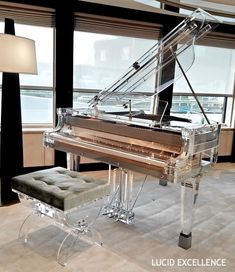 a grand piano in a living room next to a window