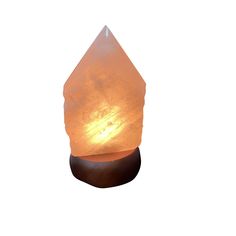 a himalayan stone lamp on a wooden stand with a white background and light shining through the top