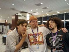 three young men posing for the camera in an airport