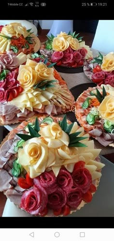 cupcakes decorated with flowers and leaves on a table