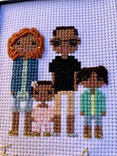 a cross stitch picture of a family holding hands