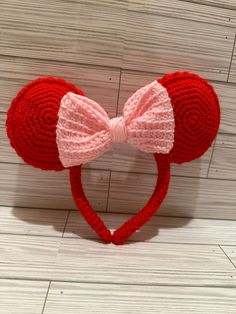 a red knitted mouse ears with a pink bow