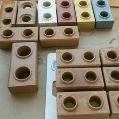 there are many different colored bricks on the floor together, and one has holes in it