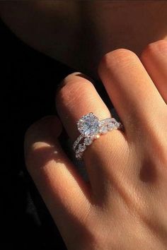 a woman's hand with an engagement ring on her finger and the words, this ring