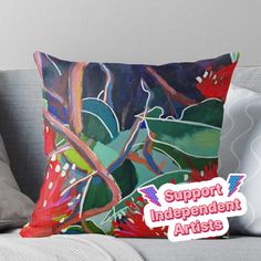 a colorful pillow with the words support independent artists on it and an image of leaves