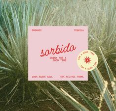 there is a sign that says sorbia on the side of a plant in front of other plants