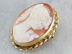 This cameo is stunning! Crafted of yellow gold, this piece can be worn as a pin or a pendant, thanks to the clever locking mechanism and swivel bail. The portrait of the lady is fun and charming. This piece dates to the 1960s or 1950's, judging by the hairstyle. This pendant does not come with the chain shown. Please feel free to contact us, we will help you find the perfect chain for your style and budget! Metal: 14K Yellow Gold Gem: Cameo Measures: 27 mm x 21 mm Marks: “14K CC” Stamped on the Gold Brooch, Cameo Ring, Vintage Cameo, Locking Mechanism, Cameo Brooch, Gold Brooches, July Birthstone, The Lady, Coral Color