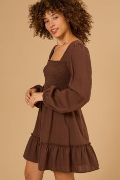 This babydoll dress features a flattering fit and flare silhouette. The long sleeves add a touch of sophistication, making it perfect for both casual and special occasions. Long Sleeve Dress With Ruffle Hem For Brunch, Flowy Square Neck Mini Dress For Fall, Long Sleeve Midi Dress With Ruffle Hem, Chic Brown Long Sleeve Dress For Spring, Long Sleeve Mini Dress With Ruffle Hem For Brunch, Flowy Mini Dress For Fall, Long Sleeve Dresses With Smocked Back For Day Out, Long Sleeve Dress With Gathered Sleeves For Fall, Fall Long Sleeve Dress With Gathered Sleeves